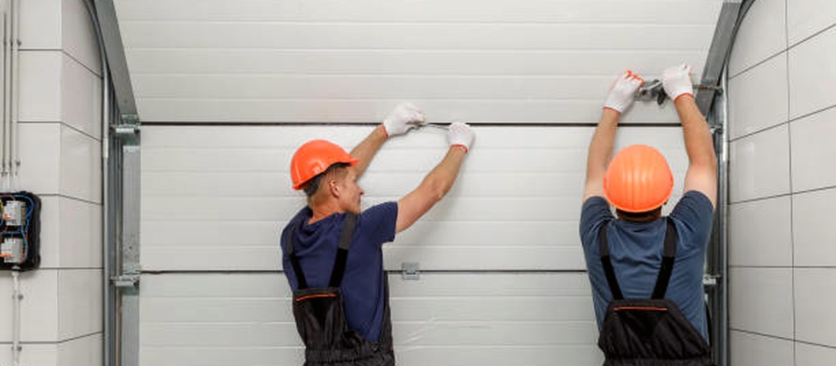 Technicians installing a residential garage door